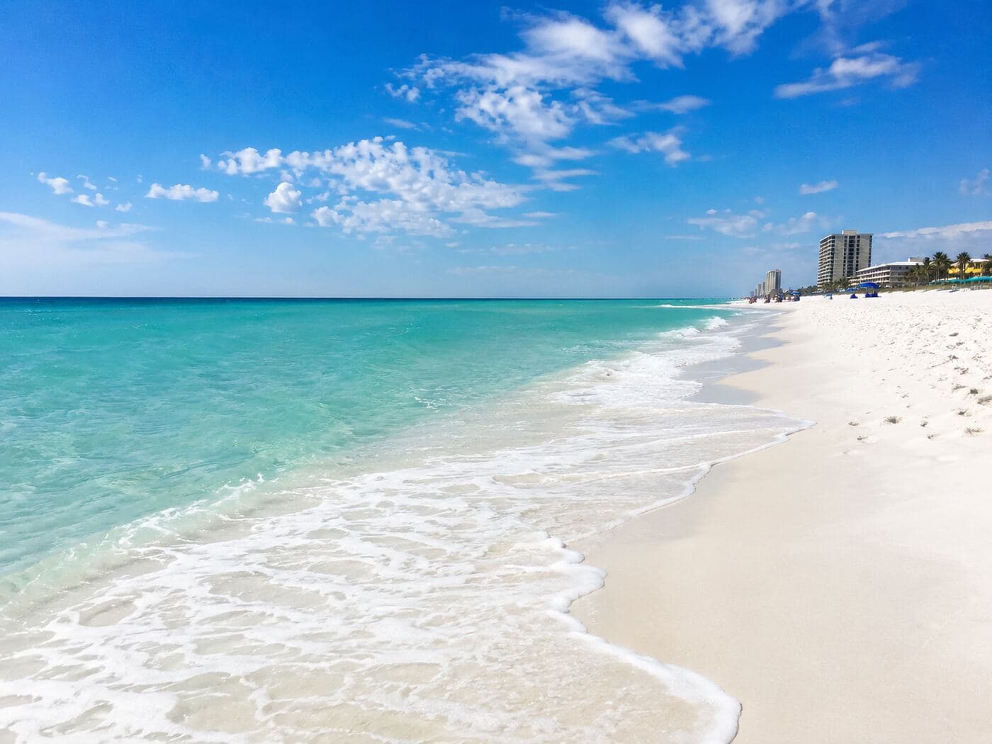 Emerald Gulf water meeting the white sand in Panama City Beach